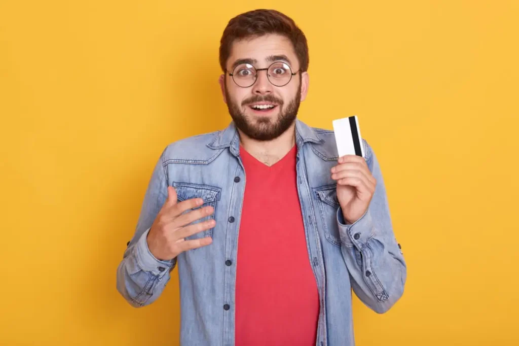 Man holding debit card in hand